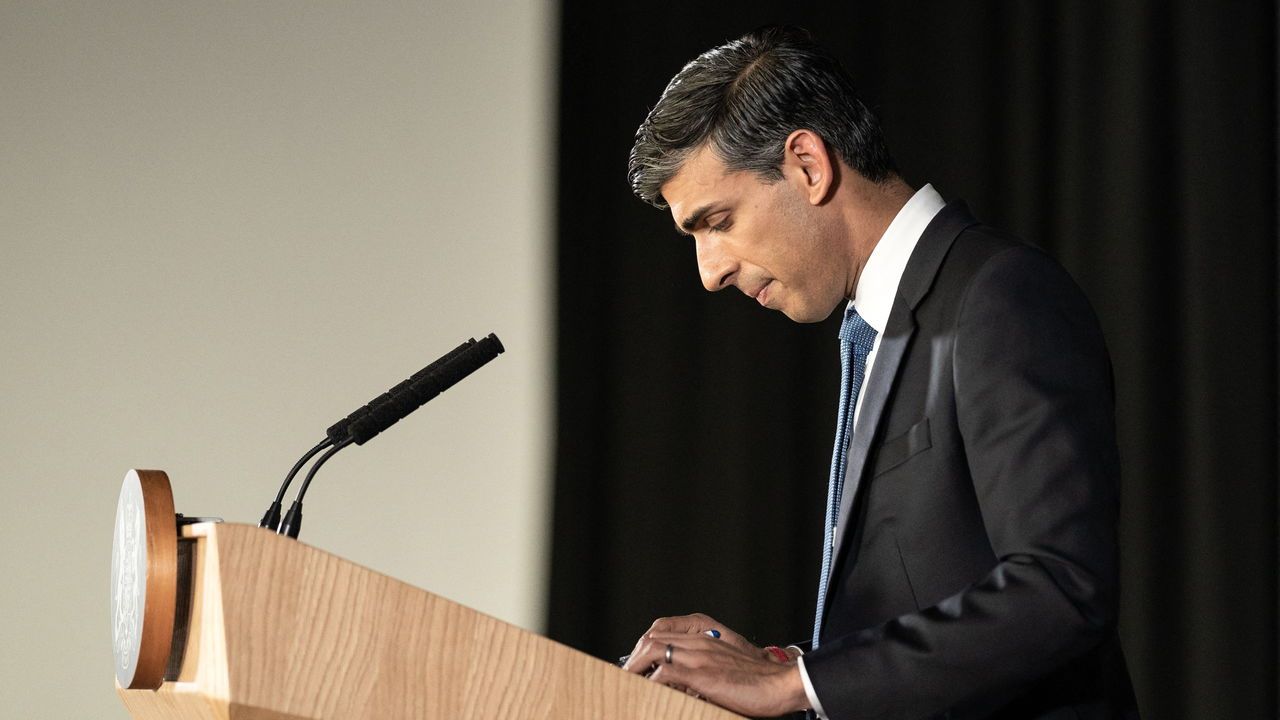 Britain's Prime Minister Rishi Sunak looks down whilst delivering a speech.