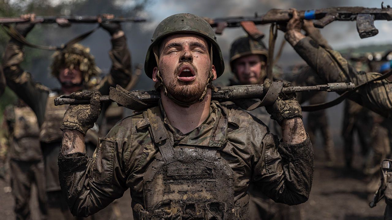 Exhausted members of Ukraine's 36th Brigade undertake a seven kilometer obstacle course