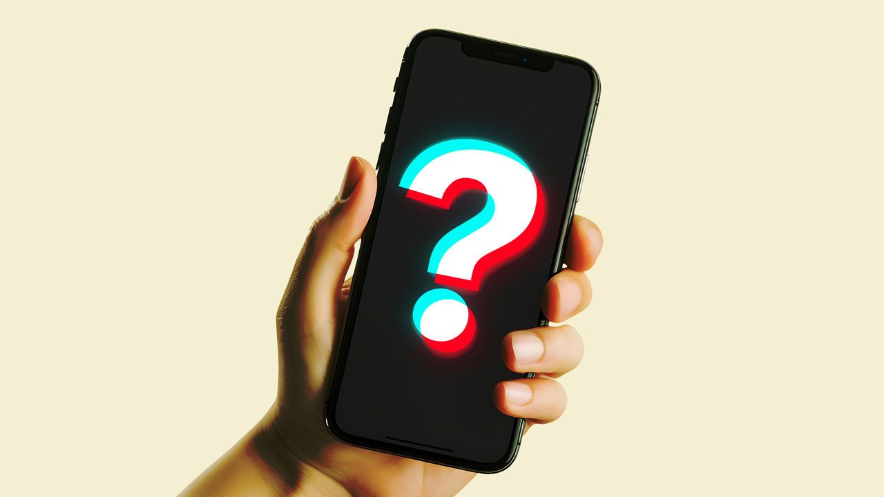 A hand holding a smartphone with the screen illuminated. The screen displays a question mark overlaid with the TikTok logo.