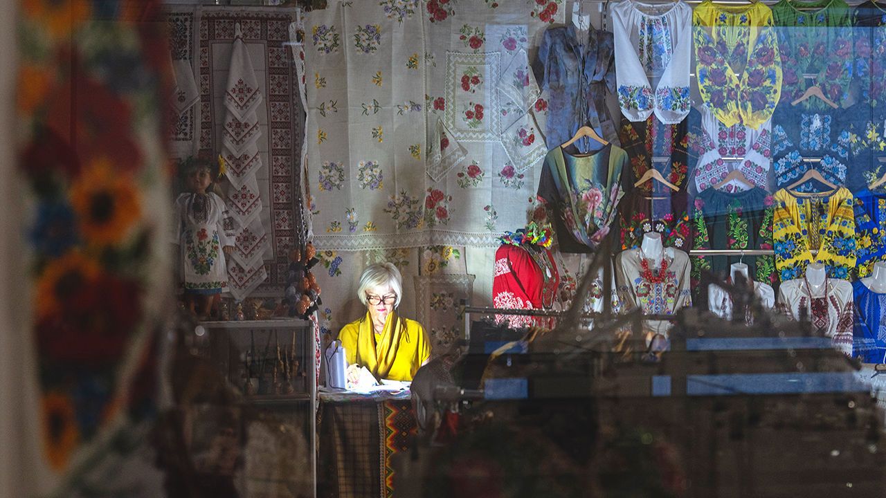 A shopkeeper shines a torch during a blackout in an underground shopping mall in central Kyiv, Ukraine, June 19th 2024