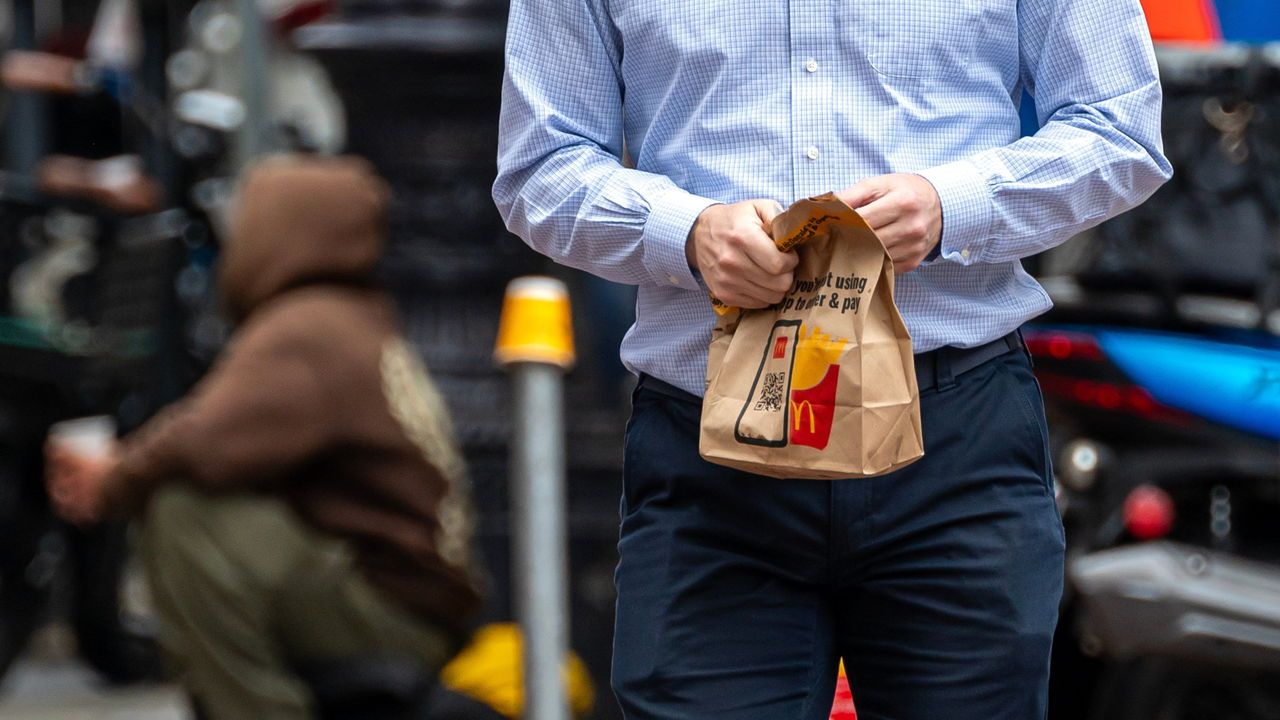 A pedestrian carries a McDonald's bag in San Francisco, California,