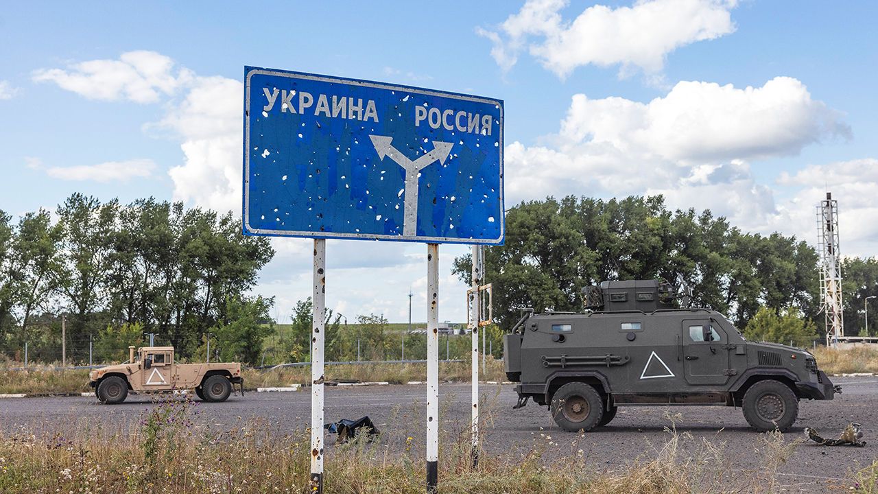 A Russian sign reading Ukraine, left, and Russia, right, near the destroyed Russian border post on the Russian side of the Sudzha border crossing.