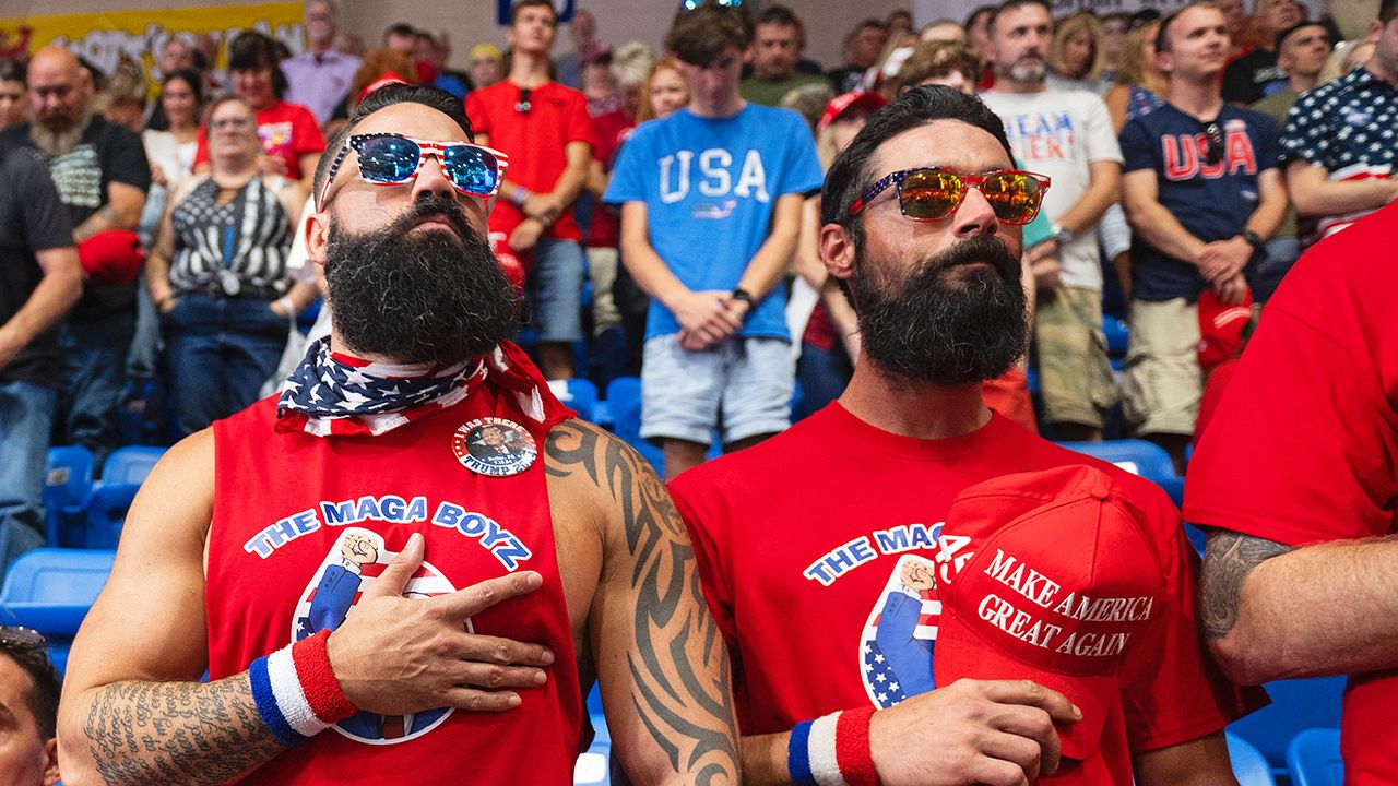 Two men hold their hands to their hearts during a political rally, in Pennsylvania, where former US President and presidential candidate Donald Trump spoke.