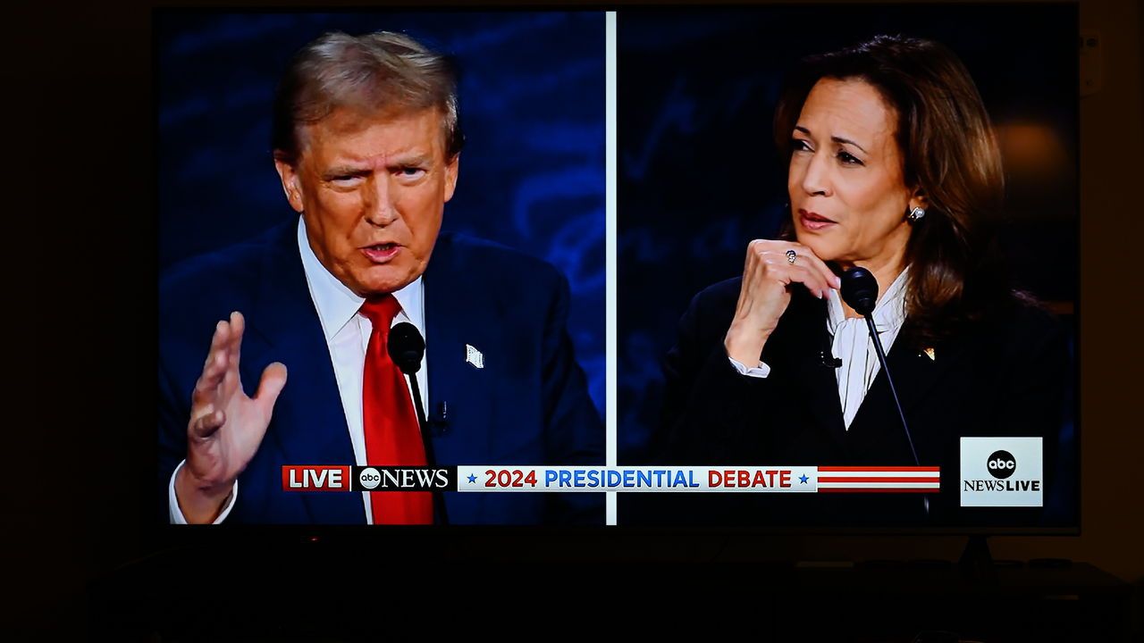 Former President Trump and Vice President Harris during the Presidential Debate is displayed on a TV screen