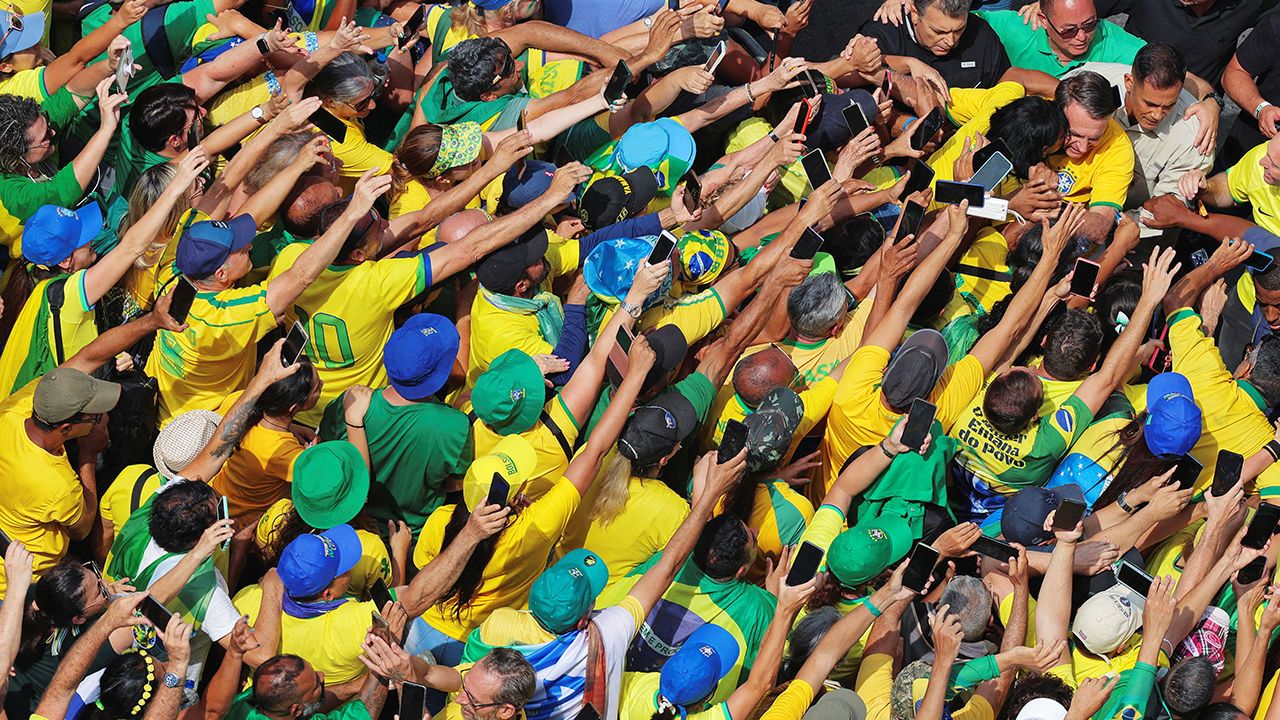 Brazil's former president Jair Bolsonaro greets supporters.