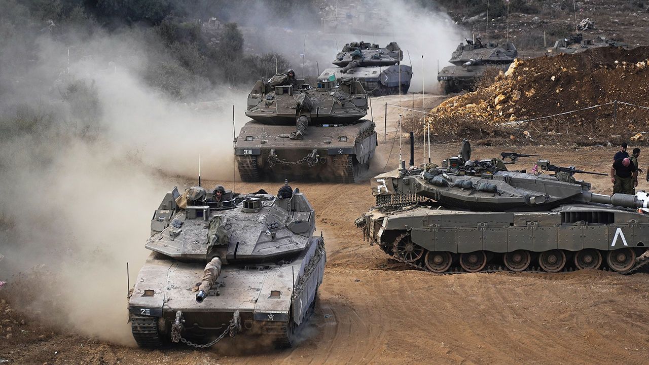 Israeli army tanks manoeuvres in a staging area in northern Israel near the Israel-Lebanon border